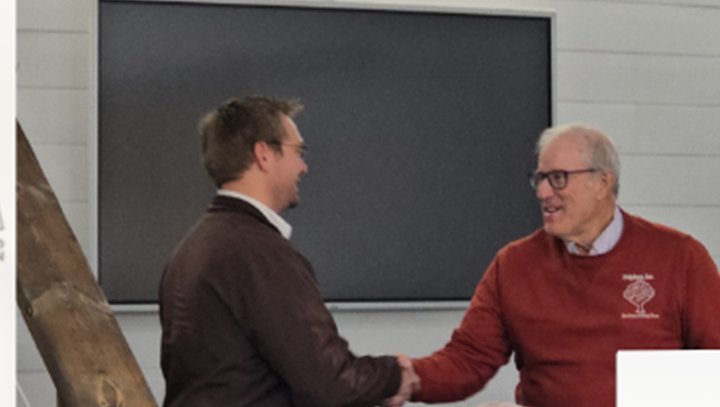 Jamon Mysliwiec shaking hands with Joel Salatin of Polyface Farms at a TIAG event